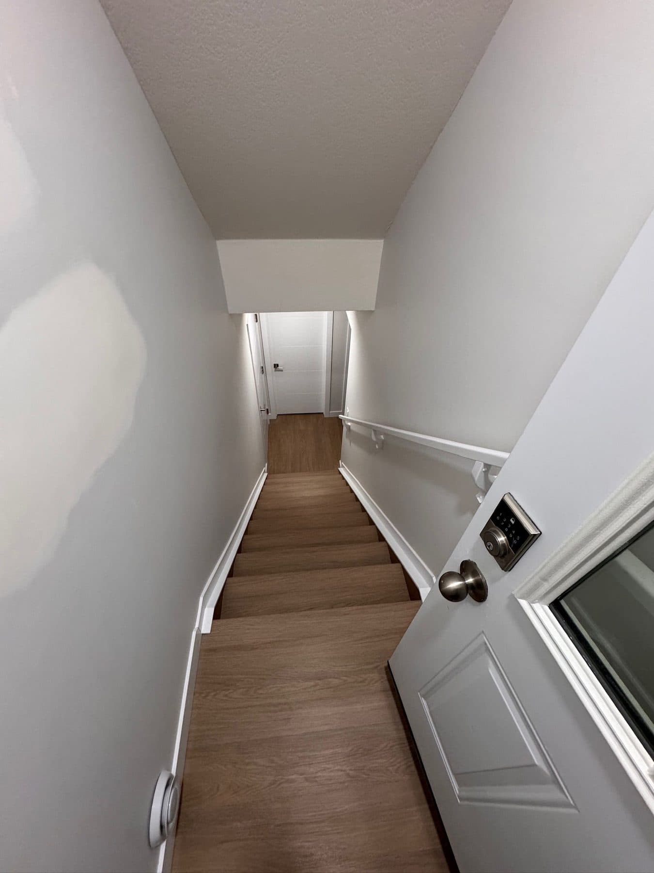 Cleaned suite stairwell and landing with handrail, painted walls and finished stair treads.